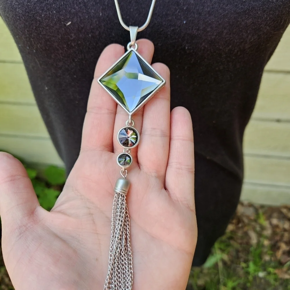 long silver tone chain necklace with tiered gray pendant and tassel